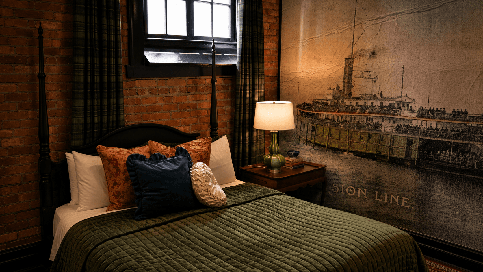 The Director's Room hero at The Library Historic Hotel — accessible queen suite with historic brick