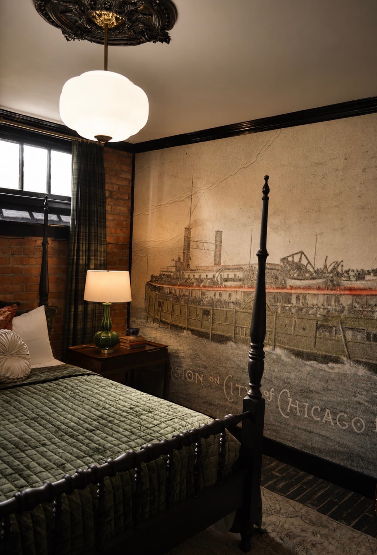 The Director's Room at The Library Historic Hotel — queen bed with exposed historic brick