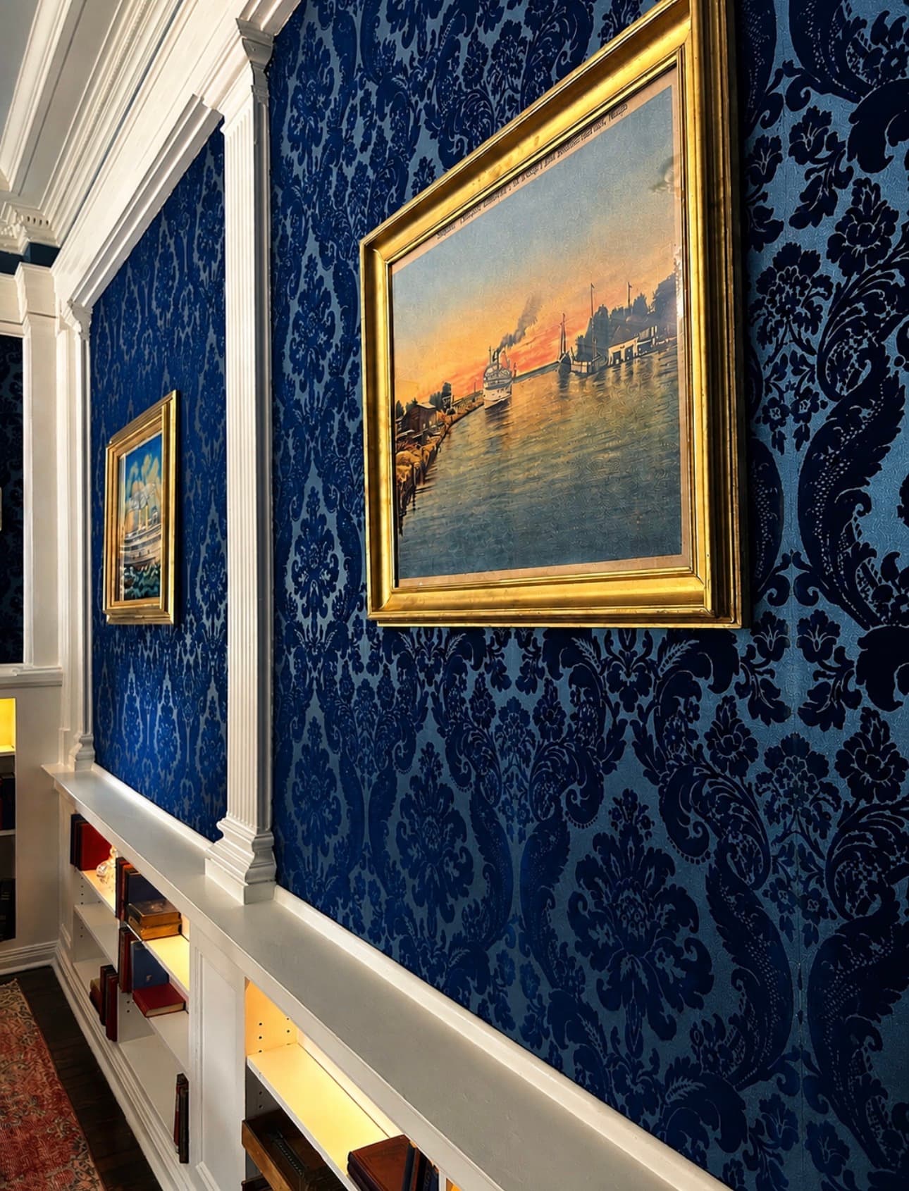 The Reading Room at The Library Historic Hotel — king bed framed by restored 1904 bookcases